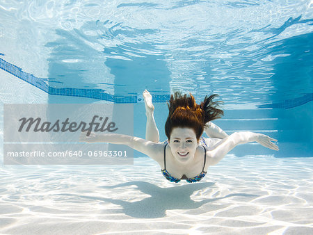 USA, Utah, Orem, Smiling woman swimming in swimming pool