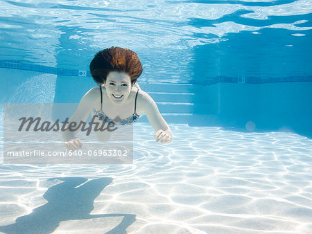 USA, Utah, Orem, Smiling woman swimming in swimming pool