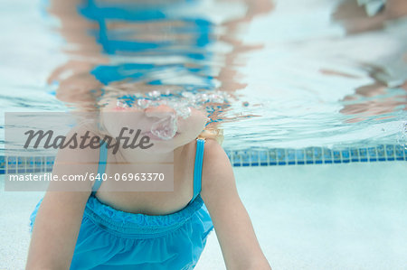 USA, Utah, Orem, Girl (2-3) swimming in pool