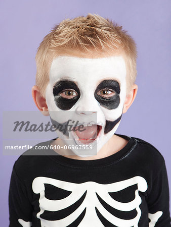 Portrait of boy (2-3) in skeleton costume for Halloween