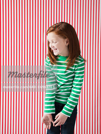 Studio shot of girl (4-5) laughing