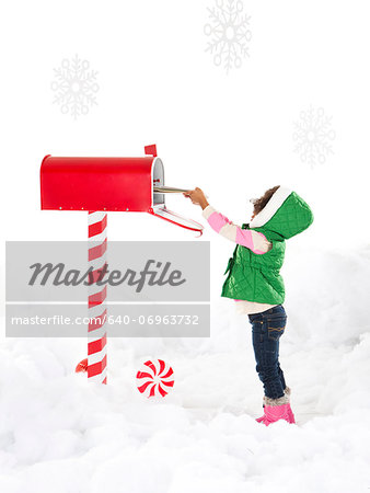 Girl (4-5) sending letter to Santa