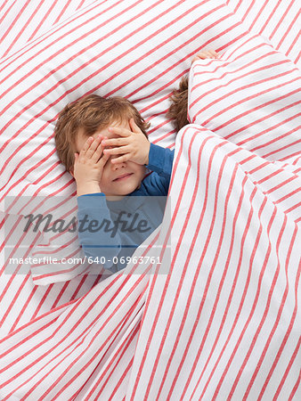 USA, Utah, Orem, Twin boys (2-3) wearing pajamas playing on bed