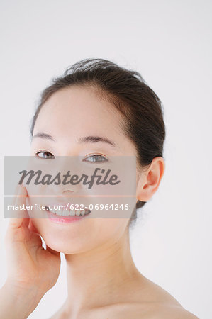 Young woman with no make-up smiling at camera