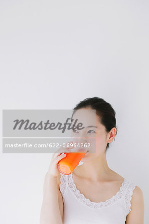 Young woman drinking vegetable juice