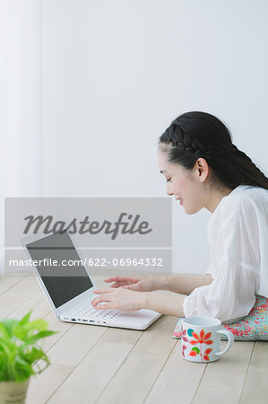 Young woman with laptop in the living room