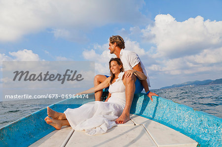 Man and woman embracing in bow of boat