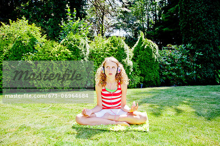 Teen girl meditating outdoors