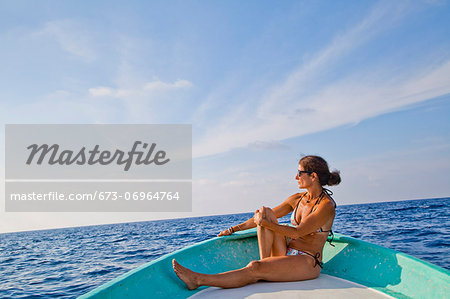 Woman sitting in bow of boat