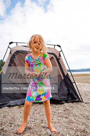 Young girl in front of tent on beach