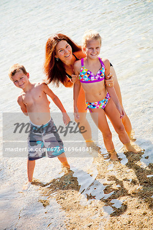 Family standing in shallow water