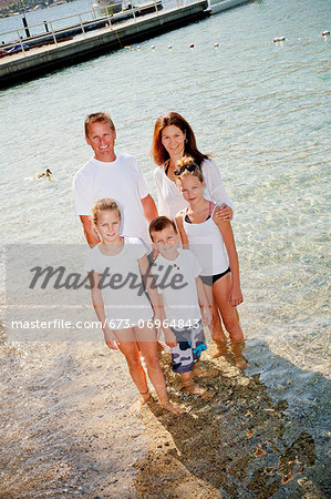 Family standing in shallow water