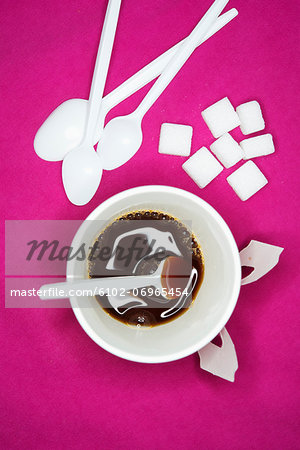 Sugar cubes and coffee cup, studio shot Sugar cubes and coffee cup, studio shot