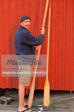 Man painting oar