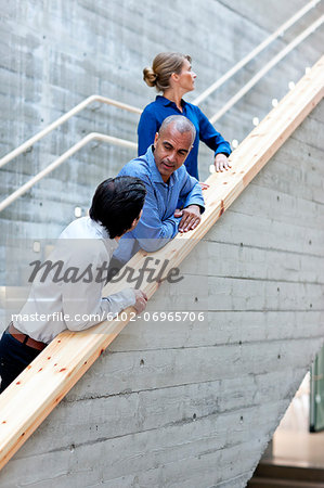 Men and woman talking on stairs