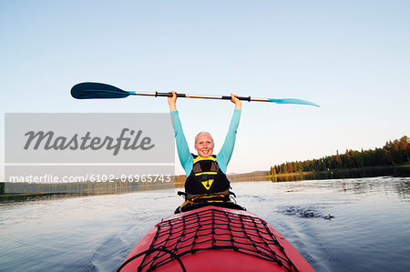 Smiling woman holding paddle