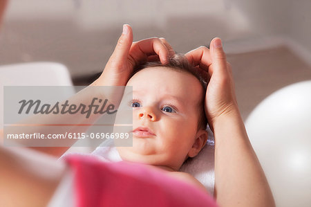 Baby boy receiving treatment from osteopath, Munich, Bavaria, Germany