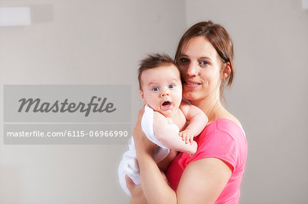 Mother holding baby in her arms, Munich, Bavaria, Germany