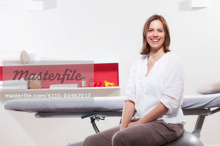 Female osteopath sitting in Physiotherapy Practice, Munich, Bavaria, Germany