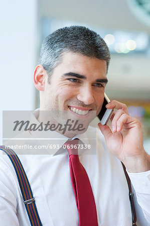 Close-up of businessman smiling on mobile phone