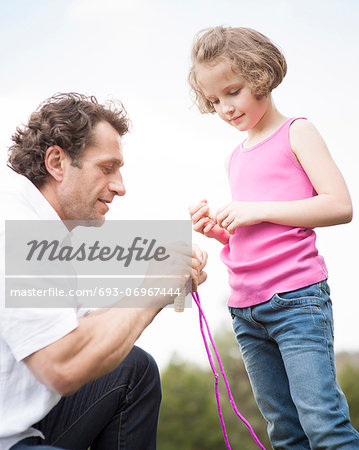 Father and daughter together with skipping rope