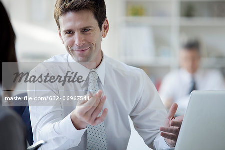 Businessman talking with colleague in office