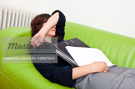 Businesswoman sleeping on a sofa