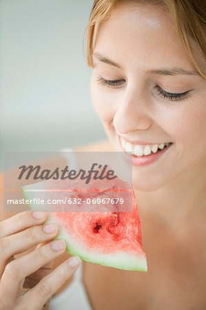 Young woman eating watermelon