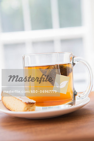 Cup of Tea in Clear Mug with Lemon Biscotti, Studio Shot Cup of Tea in Clear Mug with Lemon Biscotti, Studio Shot