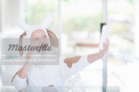 Girl taking picture of herself drinking glass of milk