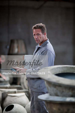 Fetching potters wheel at pottery factory