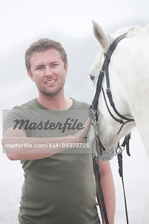 Man with horse on beach