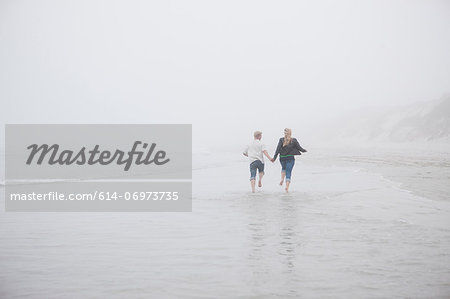 Couple running on beach