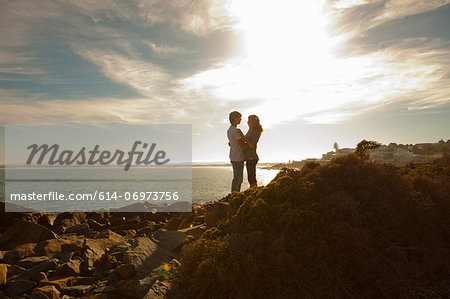 Young couple hugging on coastline