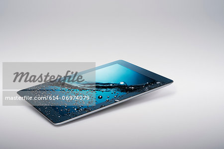 Digital tablet with gently rising bubbling water on screen