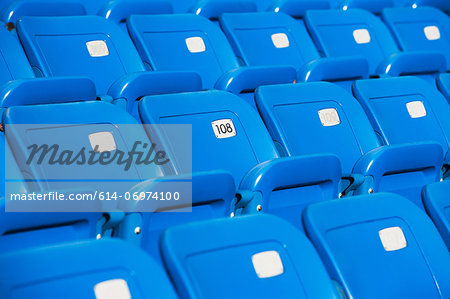 Empty blue seating in sports stadium