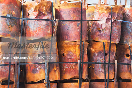 Stacked rusting barrels in a row Stacked rusting barrels in a row