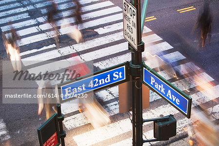 Park Avenue street sign and blurred pedestrians crossing road New York City, USA