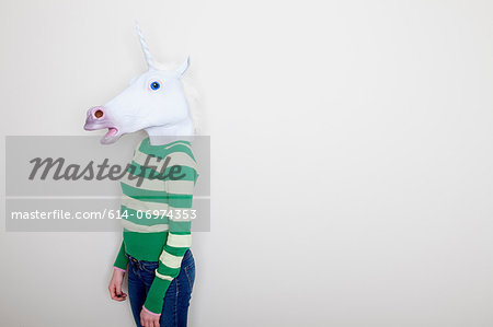 Girl wearing unicorn head