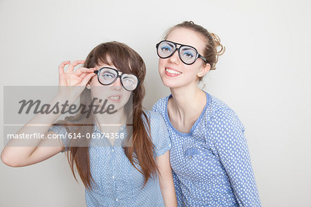 Two girls wearing fake glasses