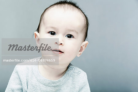 Portrait of baby boy wearing grey top