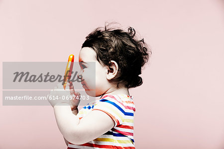 Portrait of baby girl holding plastic toy Portrait of baby girl holding plastic toy