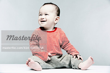 Portrait of baby boy wearing striped top looking away