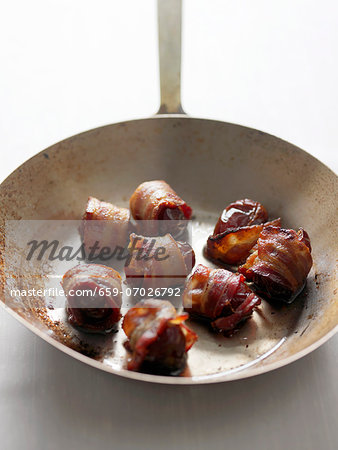 Dates Wrapped in Bacon in a Wok