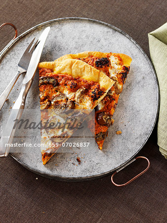 Two Slices of Mushroom Pizza with a Fork and Knife