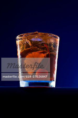 An Old Fashioned Cocktail with an Orange Slice and a Cherry An Old Fashioned Cocktail with an Orange Slice and a Cherry