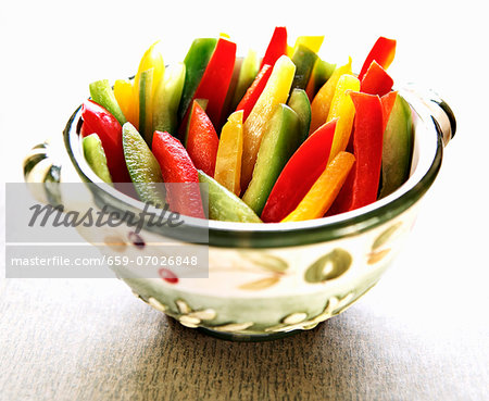 Red, Green and Yellow Bell Pepper Slices in a Decorative Bowl Red, Green and Yellow Bell Pepper Slices in a Decorative Bowl