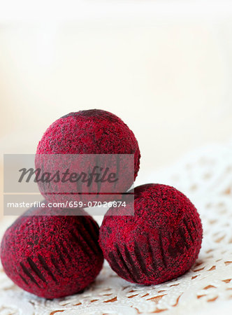 Three Chocolate Truffles with Red Sugar Crystals; Stacked