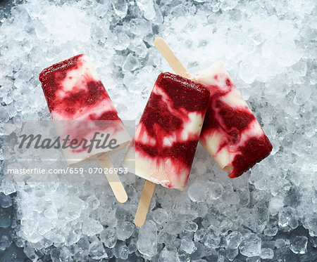 Ice lollies (raspberry and vanilla) on ice cubes