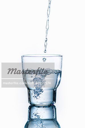 Water pouring into a glass Water pouring into a glass